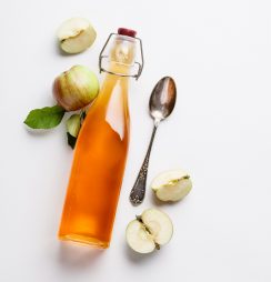 Apple cider vinegar and fresh apples, flat lay, space for your t