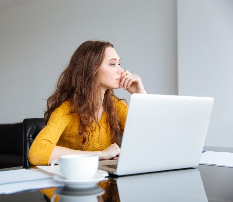 Thoughtful woman sitting at the desk